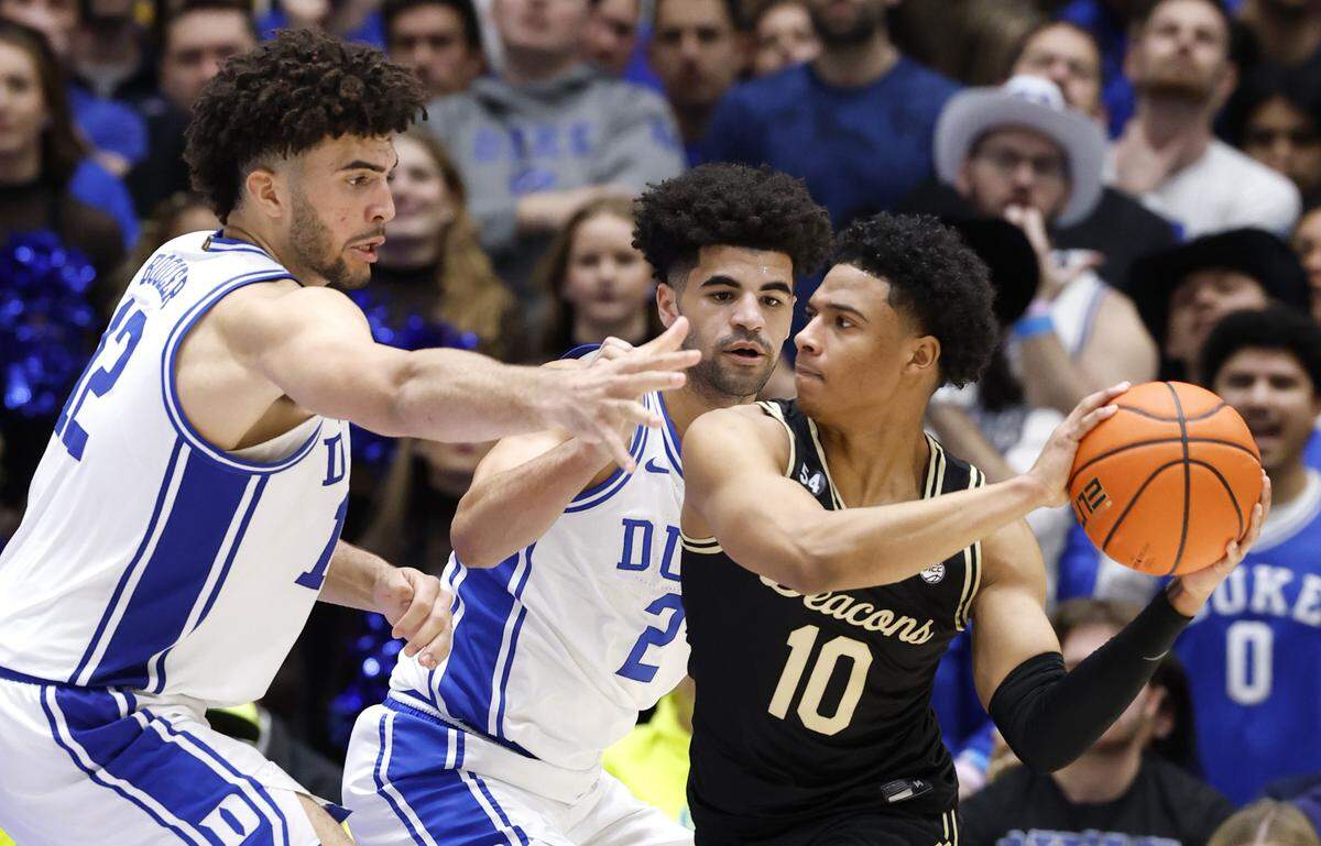 Duke’s Cameron Boozer (12) and his twin brother Cayden Boozer (2) guard Wake Forest's Sebastian Akins (10) during the second half of Duke’s 90-69 victory over Wake Forest at Cameron Indoor Stadium in Durham, N.C., Saturday, Jan. 24, 2026.