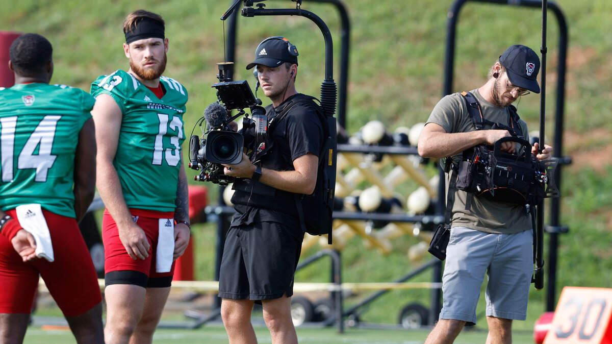 Cameras follow N.C. State’s Devin Leary during the Wolfpack’s first practice of fall camp in Raleigh, N.C., Wednesday, August 3, 2022.