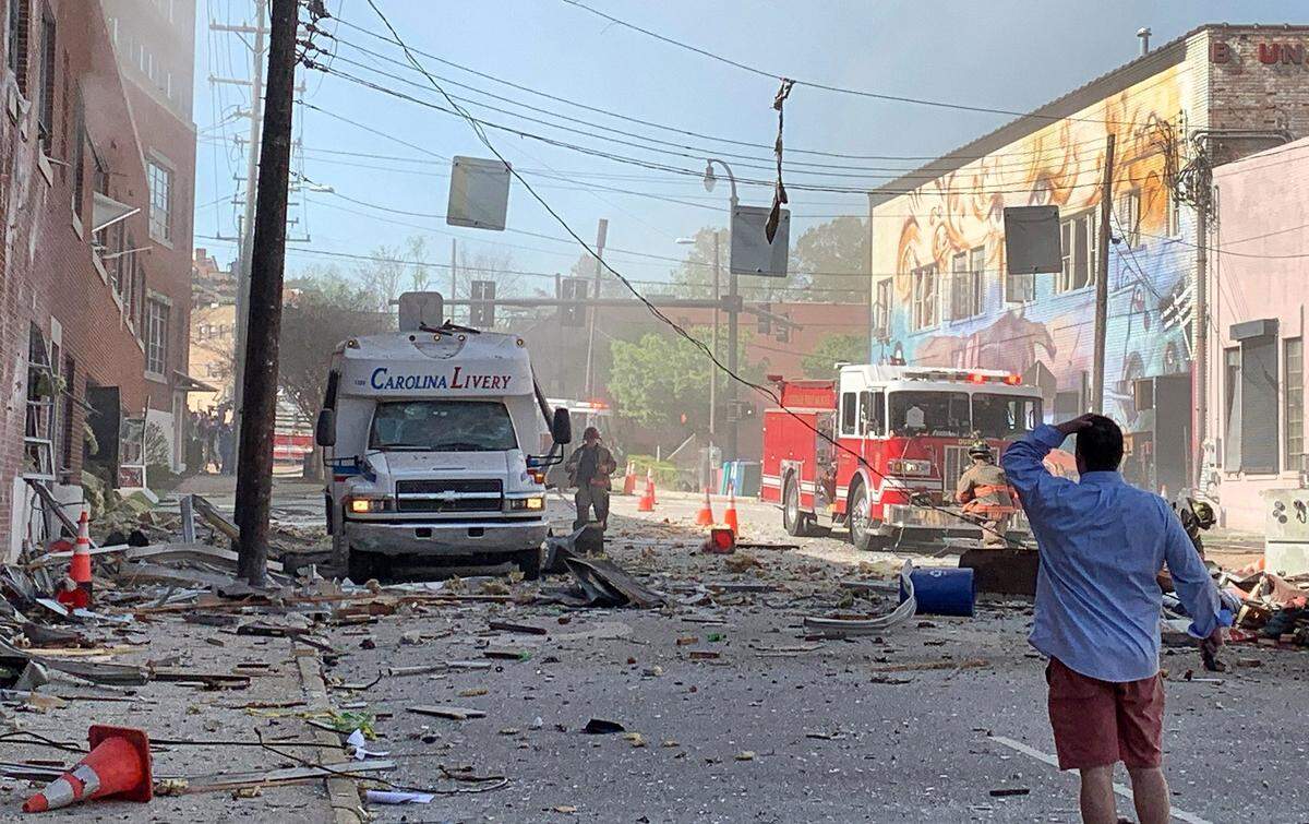The scene in downtown Durham, NC, April 10, 2019, moments after a gas explosion that killed one and injured several others. Jim Sholtz, in blue shirt, helped rescue people in the immediate aftermath. Jim Rogalski, who worked in a building across the street, shot the photo while he and his coworkers evacuated the area.