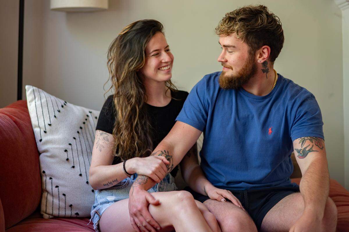 Zan and girlfriend Steph Rosen pose for a portrait in their Durham home.