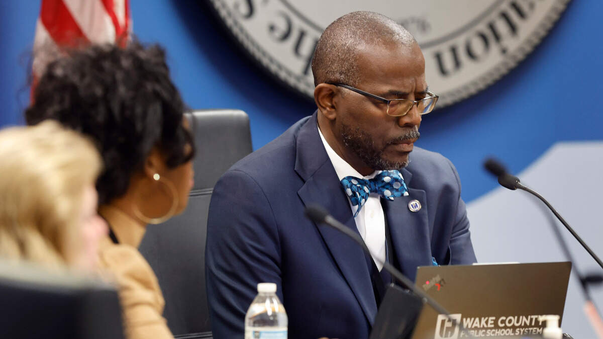 Wake County School Superintendent Robert Taylor and board members bowed their heads for a moment of silence at the start of the Wake County School Board Safety and Security meeting in Cary on Tuesday, Nov. 28. The board was going to discuss in closed session the deadly fight at Southeast Raleigh High School on Monday.