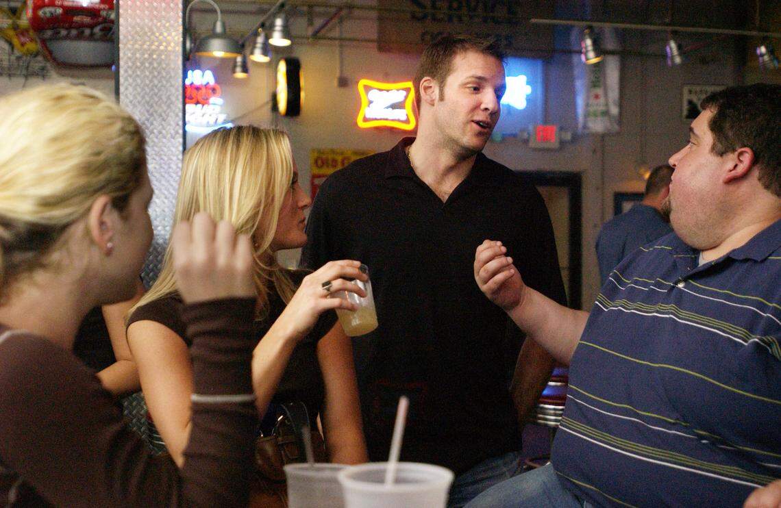 Former Carolina Hurricanes winger Bates Battaglia, second from right, talks with friends at Lucky B's Around the Corner Bar in Raleigh.  Battaglia is co-owner of the bar.