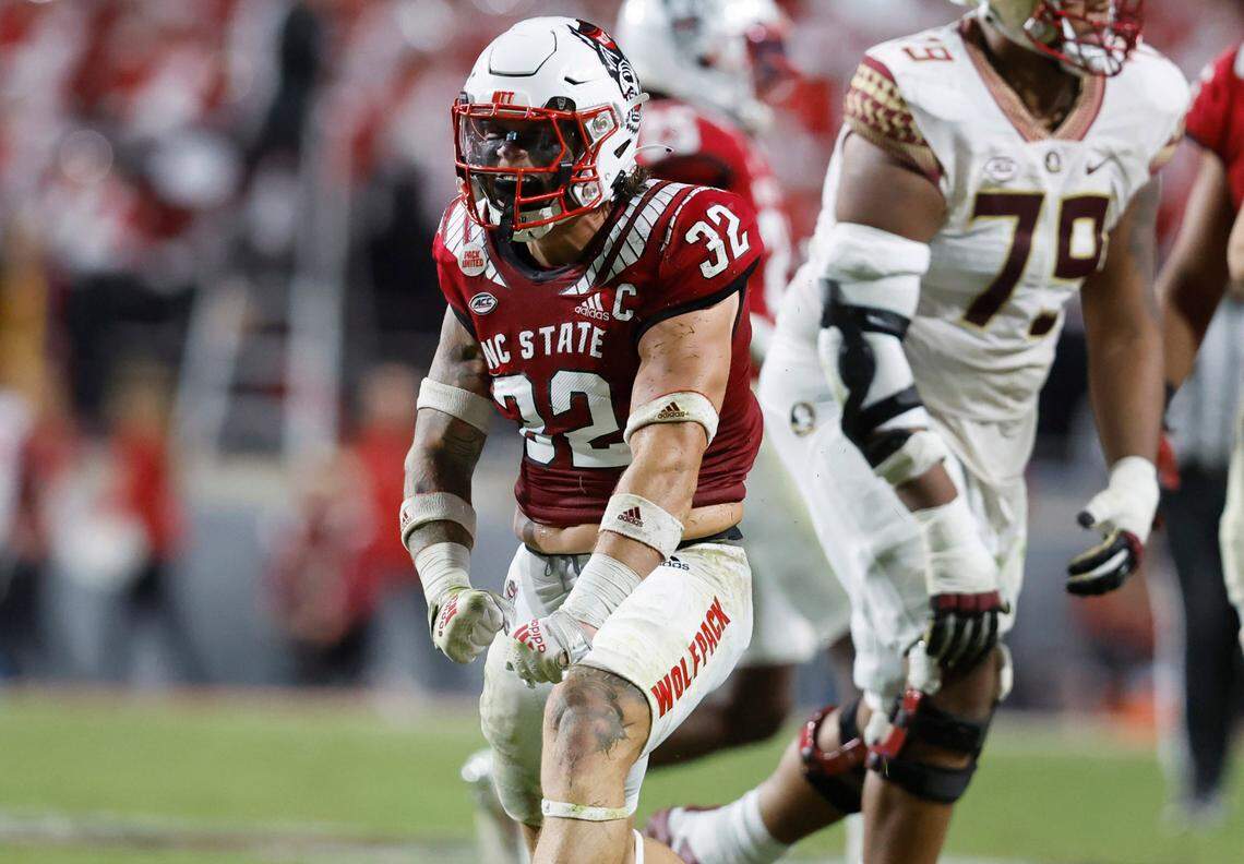 N.C. State linebacker Drake Thomas (32) celebrates after stopping Florida State running back Trey Benson (3) during the first half of N.C. State’s game against Florida State at Carter-Finley Stadium in Raleigh, N.C., Saturday, Oct. 8, 2022.