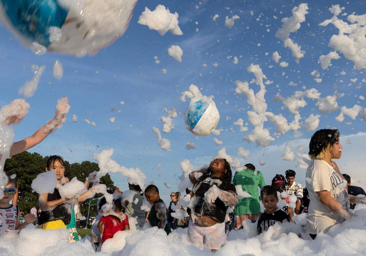 People play in a foam pit during an Independence Day celebration at Dorothea Dix Park on Tuesday, July 4, 2023, in Raleigh, N.C.