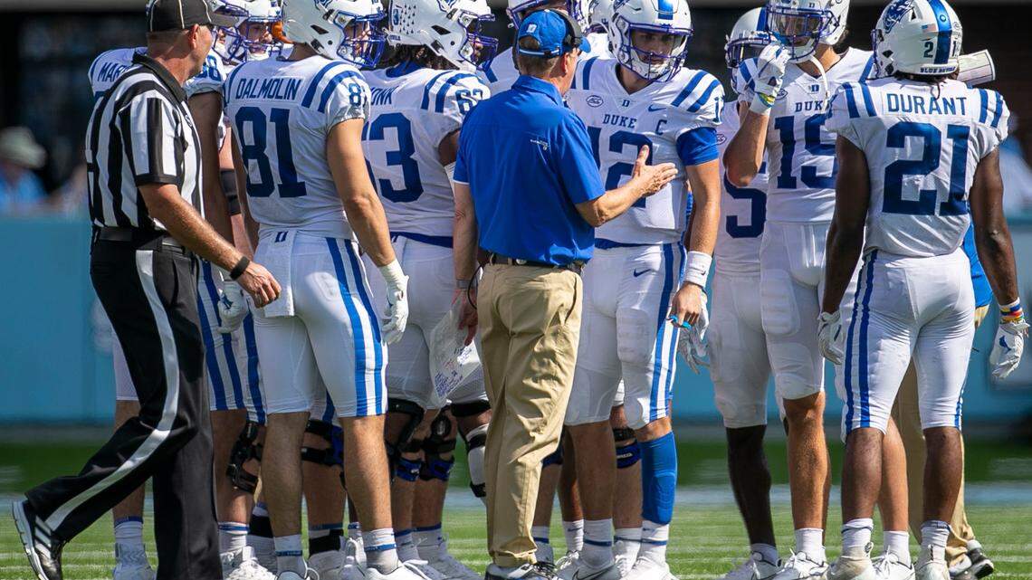 Duke coach David Cutcliffe confers with quarterback Gunnar Holmberg (12) in the fourth quarter against North Carolina on Saturday, October 2, 2021 at Kenan Stadium in Chapel Hill, N.C.