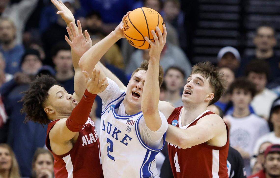 Duke’s Cooper Flagg (2) pulls in the rebound between Alabama’s Mark Sears (1) and Grant Nelson (4) during the first half of Duke’s game against Alabama in their Elite 8 game in the 2025 NCAA Men’s Basketball Championship at the Prudential Center in Newark, N.J., Saturday, March 29, 2025.