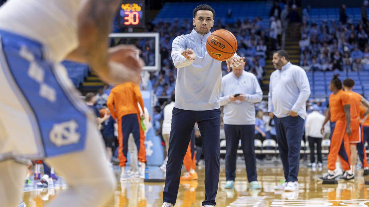 North Carolina assistant coach Marcus Paige works with players during pre-game warmups, sporting a pair of custom painted shoes on Monday, Feb. 2, 2026 at the Smith Center in Chapel Hill, N.C. The shoes were painted by patients from UNC Children’s Hospital as part of a fundraiser for the fight against pediatric cancer. Paige announced Wednesday he is joining Wes Miller’s staff at Charlotte.