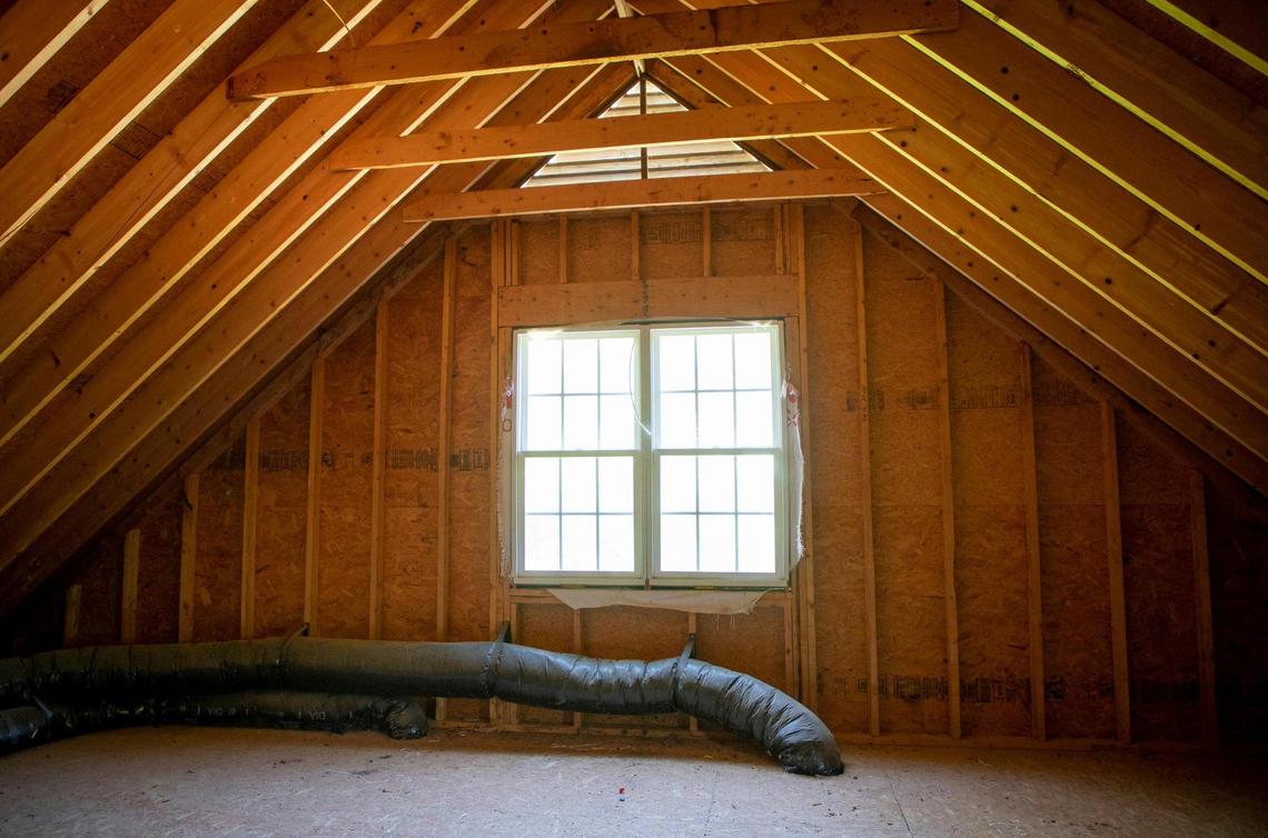Real estate agent Camille Malcolm, of United Real Estate, showed the unfinished attic of a home for sale, on Tuesday, April 27, 2021, in Durham, N.C.
