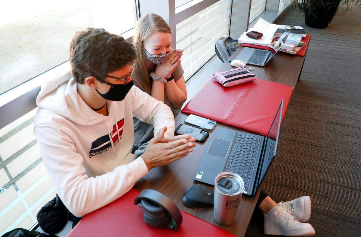 N.C. State sophomores Constantin Dornburg and Zoe Smith watch the inauguration of President Joe Biden and Vice-President Kamala Harris on a laptop in the Talley Student Union on the campus of N.C. State in Raleigh, N.C., Wednesday, January 20, 2021.