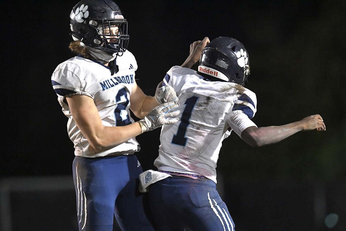 Millbrook quarterback Bryson Gray (1) celebrates the interception by Quinton Cypher (2) against Rolesville during the second half. The Rolesville Rams and the Millbrook Wildcats met in a football game in Raleigh. N.C. on October 11, 2024.