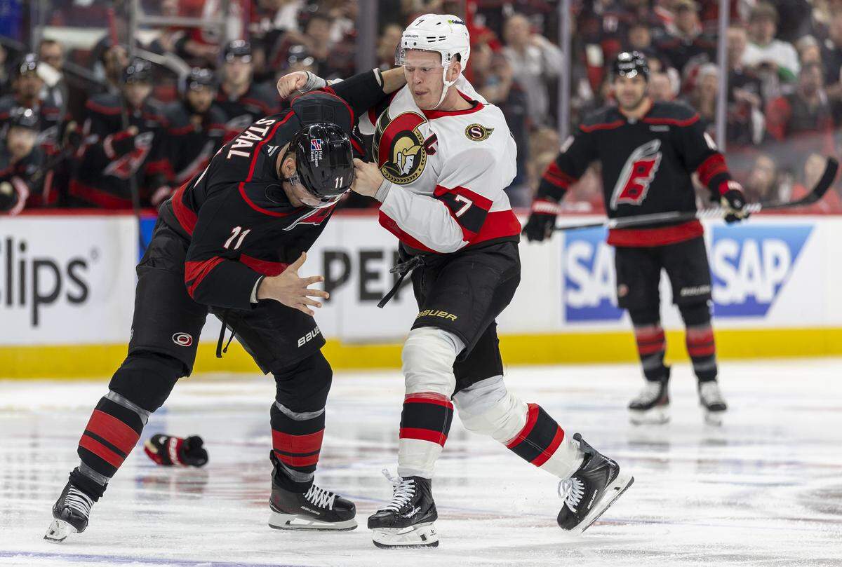 Ottawa left wing Brady Tkachuk and Carolina Hurricanes center Jordan Staal (11) drop the gloves to fight in the first period on Saturday, April 18, 2026 during the first round of the Stanley Cup Playoffs at Lenovo Center in Raleigh, N.C. 