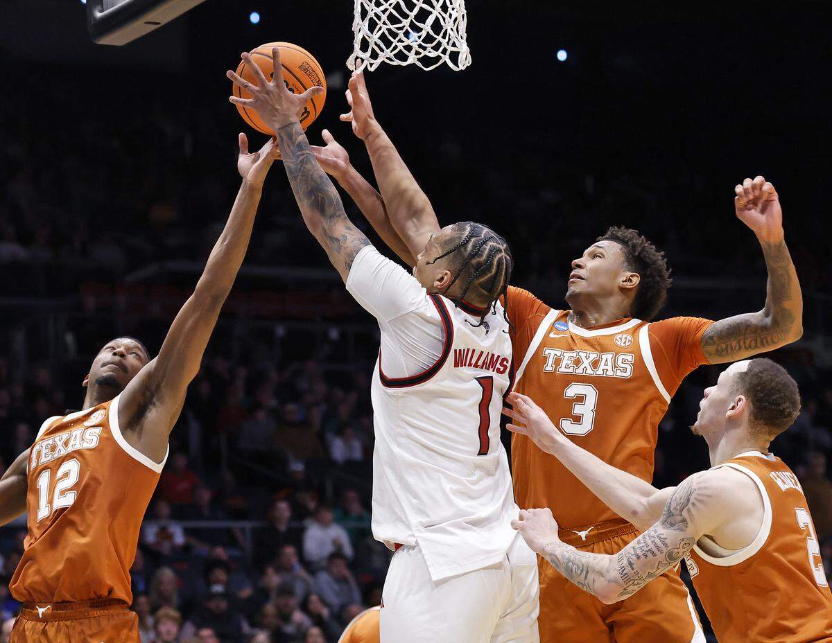 N.C. State’s Darrion Williams battles for a rebound with Texas’ Tramon Mark, Dailyn Swain and Chendall Weaver during the second half of the Wolfpack’s 68-66 loss in the NCAA First Four on Tuesday, March 17, 2026, at the University of Dayton Arena in Dayton, Ohio.