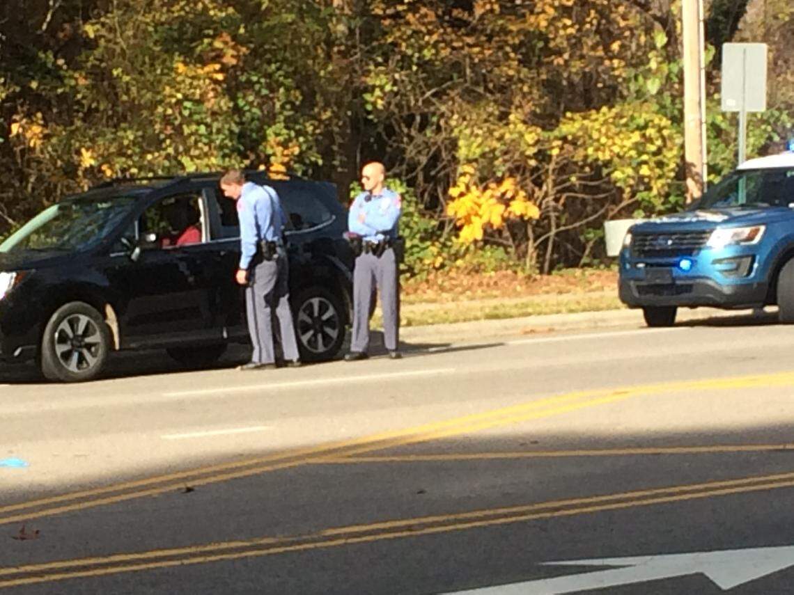 Unmasked Raleigh Police officers conduct a traffic stop on North Raleigh Boulevard on Nov. 29, 2020.