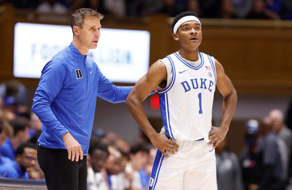 Duke head coach Jon Scheyer talks with Caleb Foster (1) during the first half of Duke’s game against Arizona State in the Brotherhood Run Charity Game at Cameron Indoor Stadium in Durham, N.C., Sunday, Oct. 27, 2024.