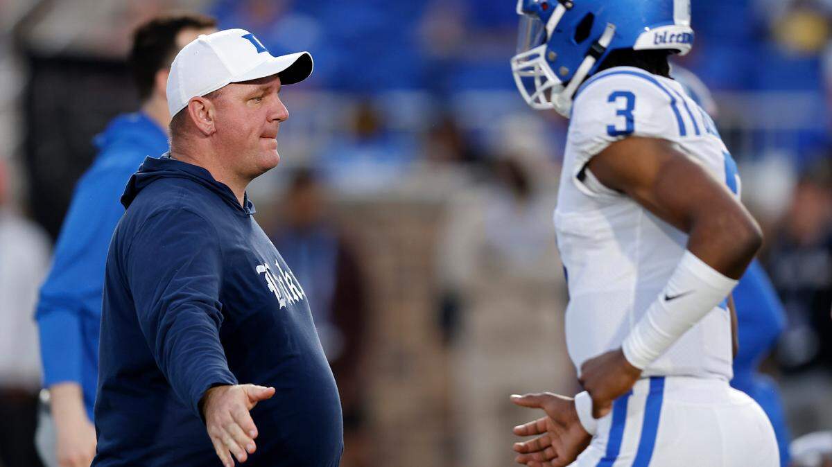 Duke head coach Mike Elko high-fives quarterback Henry Belin IV as the team warms up prior to the Blue Devils’ spring football game on Friday, April 21, 2023, at Wallace Wade Stadium in Durham, N.C.