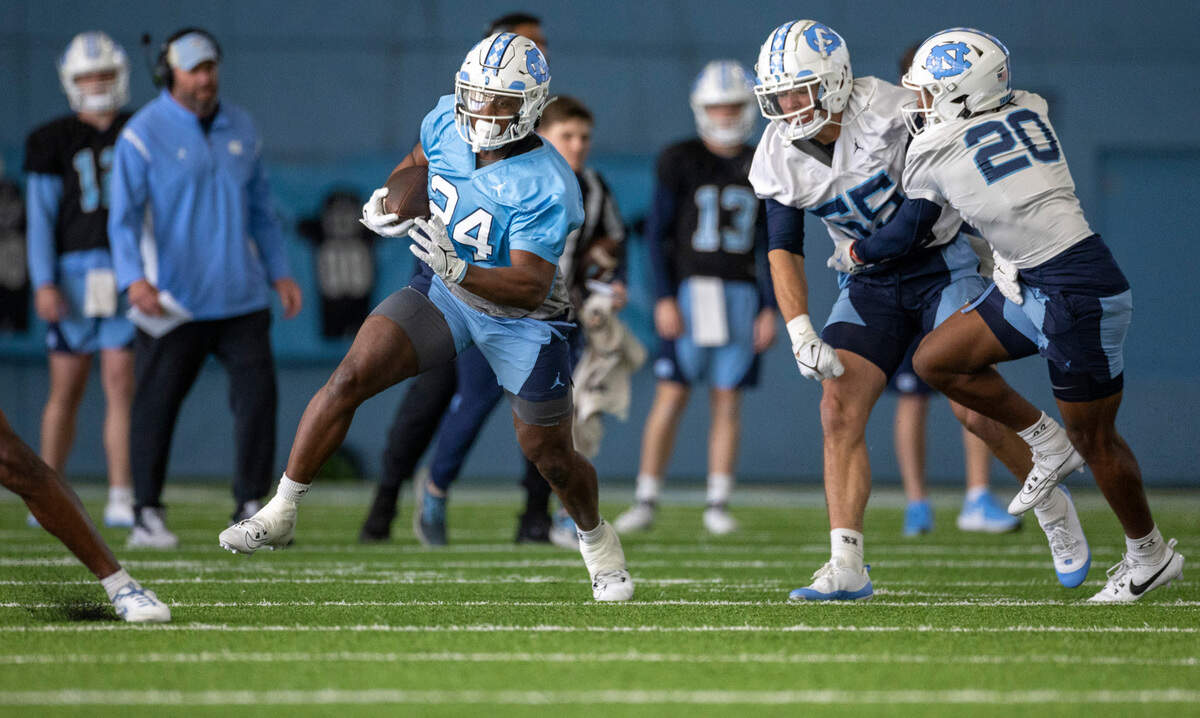 Graduate transfer Darwin Barlow (24) carries the ball during the opening day of spring football practice on Tuesday, March 19, 2024 in Chapel Hill, N.C.