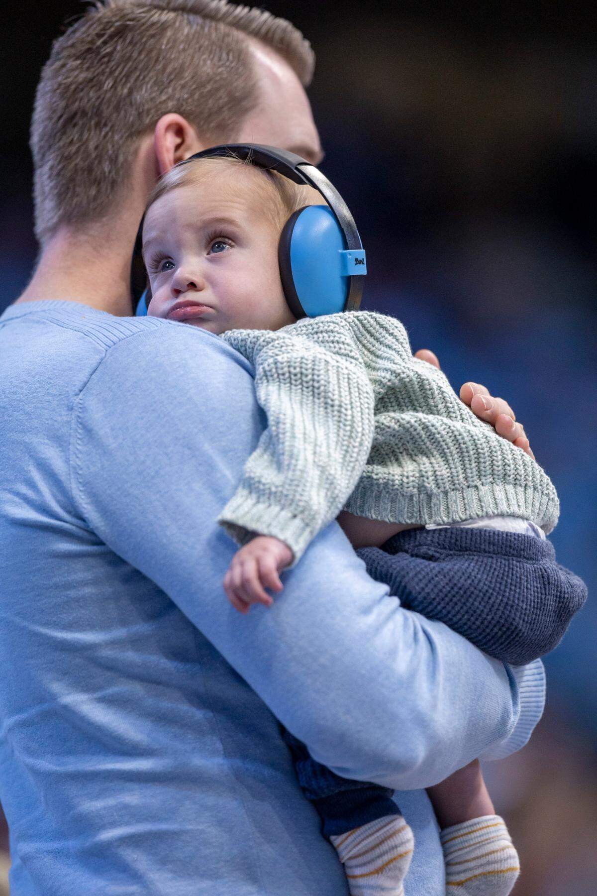 Jason Sinquefield of Durham, N.C. holds his nine-month-old son Tate at his first North Carolina basketball game on Sunday, November 12, 2023 at the Smith Center in Chapel Hill, N.C.