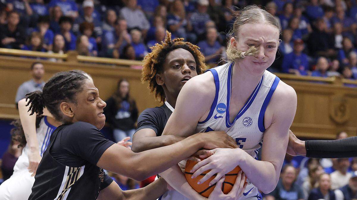 Duke’s Toby Fournier muscles a rebound away from College of Charleston’s Taryn Barbot and Taylor Barbot during the second half of the Blue Devils’ 81-64 first-round NCAA Tournament win on Friday, March 20, 2026, at Cameron Indoor Stadium in Durham, N.C.