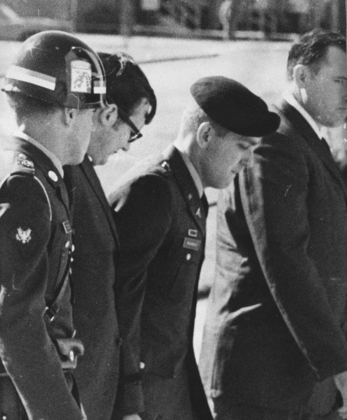 Green Beret Capt. Jeffrey MacDonald is escorted at the funeral services for his wife and two daughters at Ft. Bragg, N.C.
