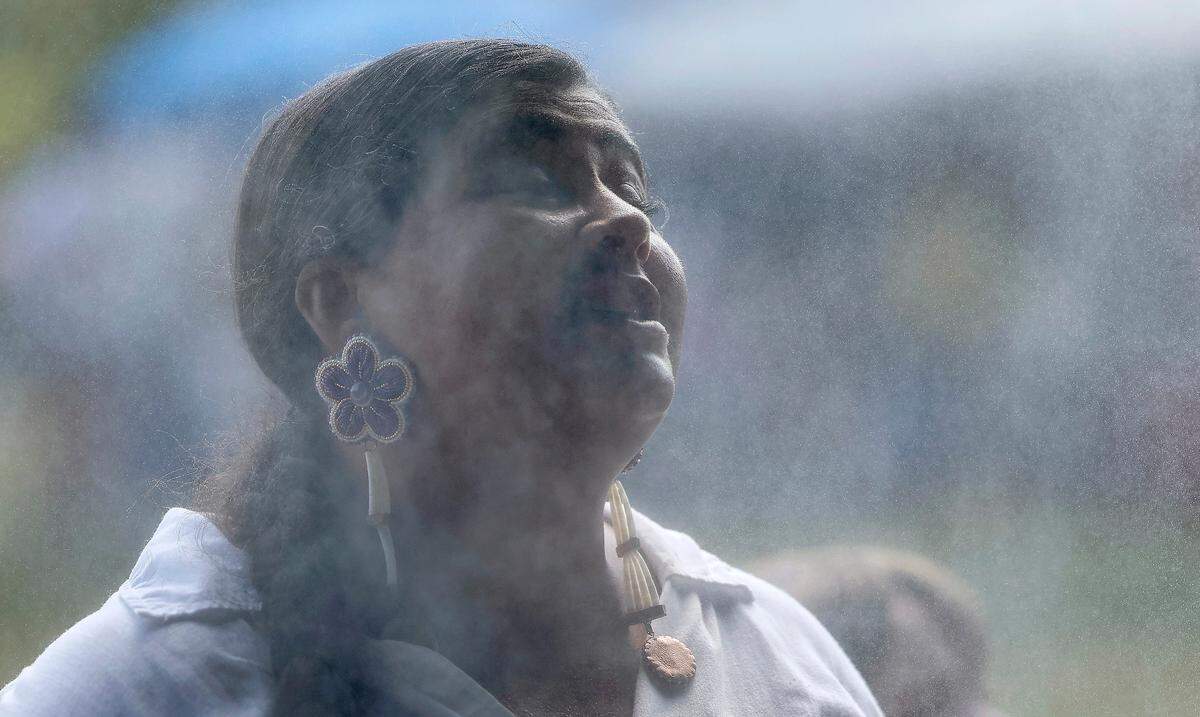 Amanda Jacobs of Pembroke, a member of the Lumbee Tribe, cools down in the cooling tent during the Dix Park Inter-Tribal Pow Wow in Raleigh, N.C., Saturday, August 26, 2023.
