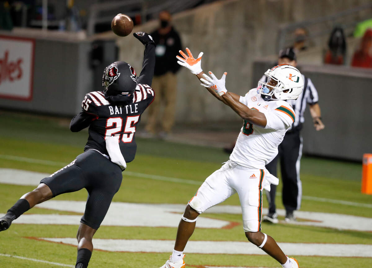 N.C. State cornerback Shyheim Battle (25) breaks up a pass intended for Miami wide receiver Mark Pope (6) during the first half of N.C. State’s game against Miami at Carter-Finley Stadium in Raleigh, N.C., Friday, Nov. 6, 2020.
