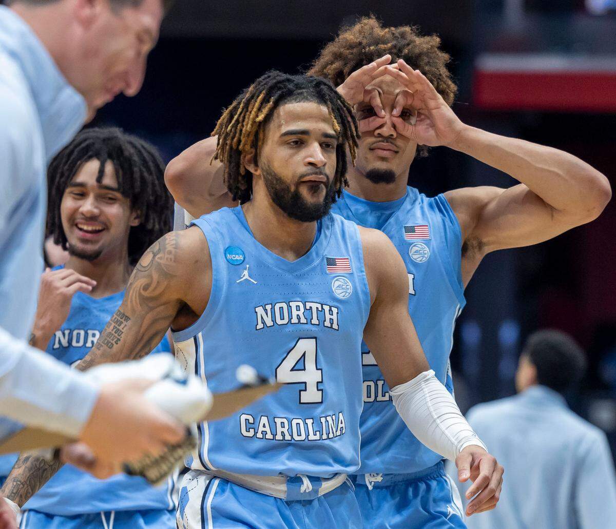 North Carolina guard Seth Trimble (7) follows guard R.J. Davis (4) into the team huddle after Davis sank a three-point basket to give the Tar Heels a 40 point lead in the second half against San Diego State on Tuesday, March 18, 2025 at the University of Dayton Arena in Dayton, Ohio.