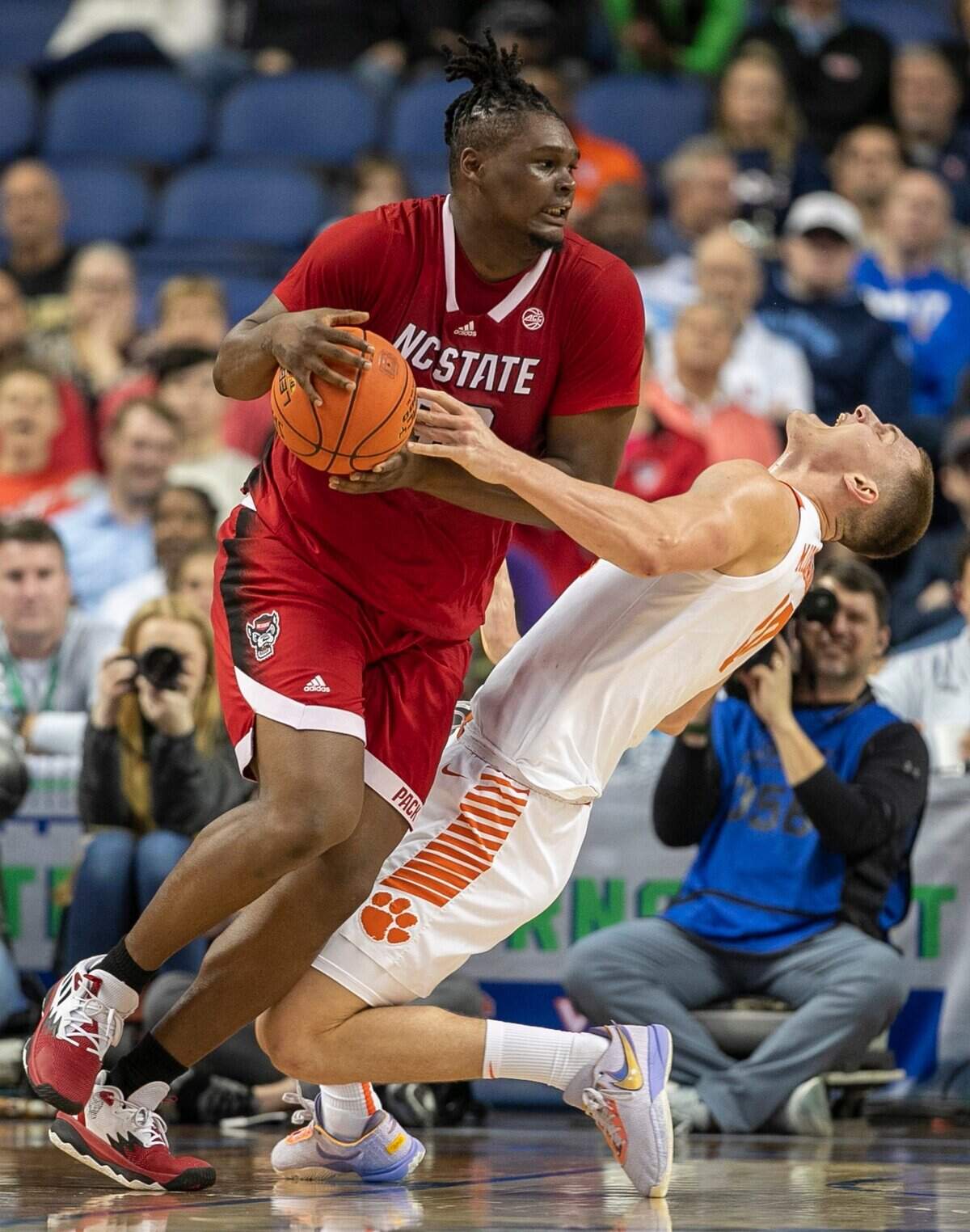 N.C. State’s D.J. Burns (30) collides with Clemson’s Ben Middlebrooks (10) in the first half during the third round of the ACC Tournament on Thursday, March 9, 2023 at the Greensboro Coliseum in Greensboro, N.C.