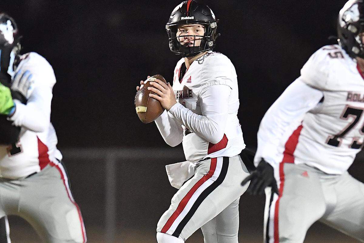 Rolesville quarterback Braden Atkinson (11) loos downfield to pass against Cleveland during the second half. The Rolesville Rams and the Cleveland Rams met in the fourth round of the NCHSAA 4A football playoffs in Clayton, N.C. on December 6, 2024.