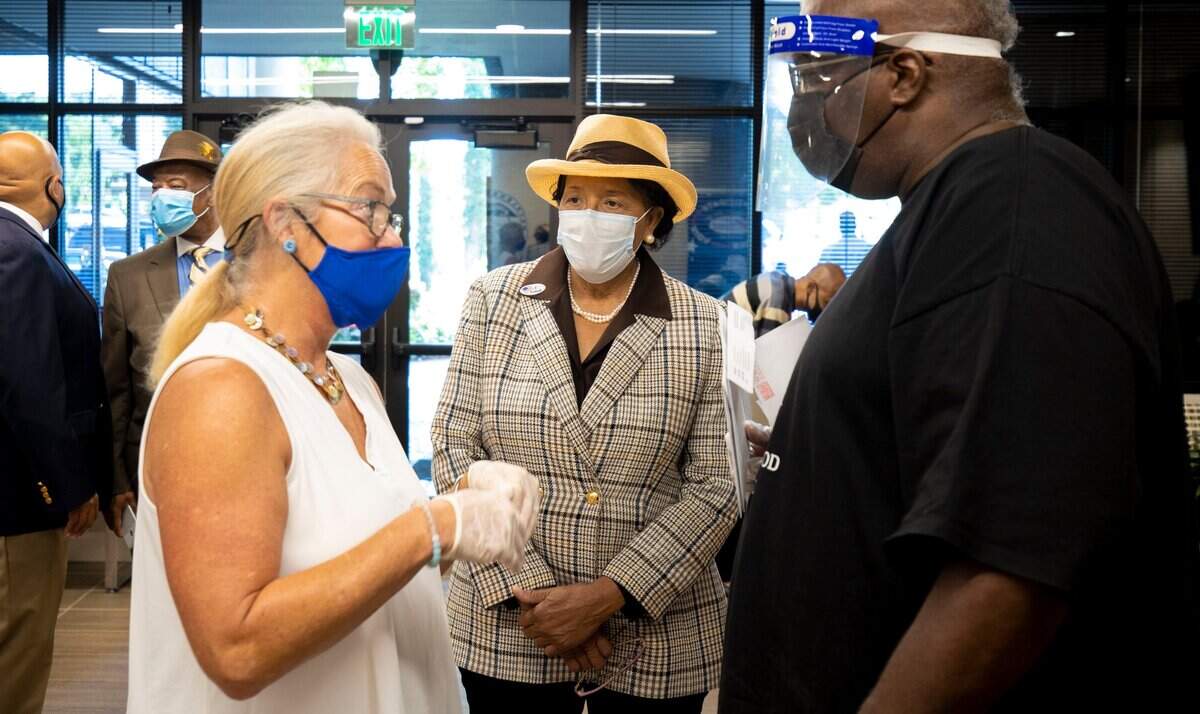 Rep. Alma Adams talks with Board of Elections employees and voters who showed up to drop off their mail in ballot directly at the Board of Elections office in Charlotte, NC on Friday, September 11, 2020.