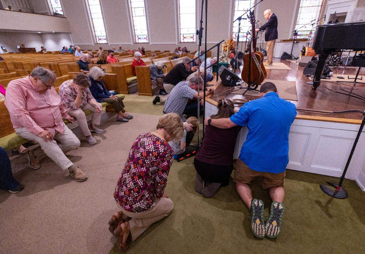 Congregants pray at the First Baptist Church in Waynesville on Sunday morning, Oct. 6, 2024. Waynesville is among the communities in western North Carolina impacted by the remnants of Hurricane Helene that caused catastrophic flooding.