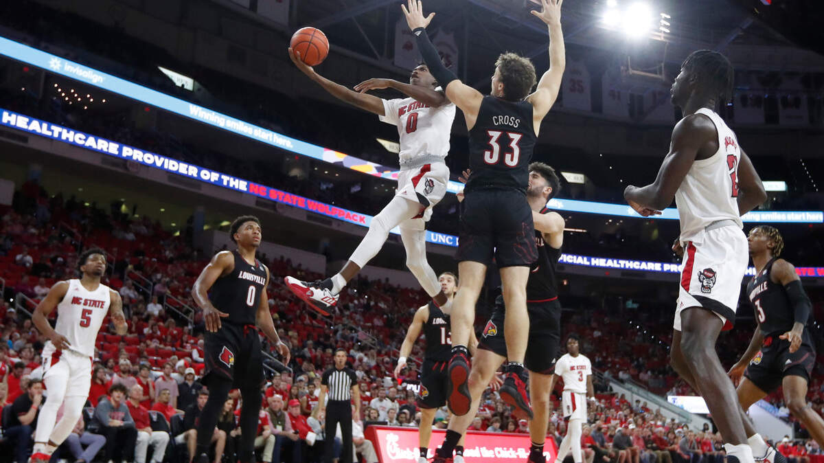 N.C. State’s Terquavion Smith (0) heads to the basket during Louisville’s 73-68 victory over N.C. State at PNC Arena in Raleigh, N.C., Saturday Dec. 4, 2021.