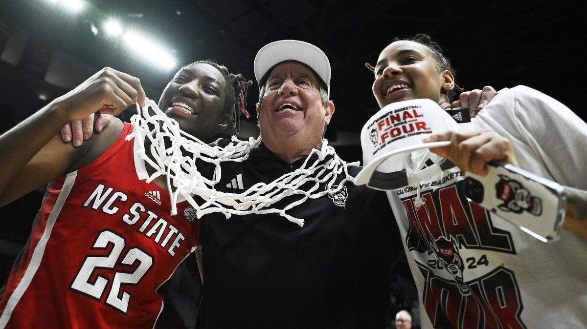 Mar 31, 2024; Portland, OR, USA; NC State Wolfpack guard Saniya Rivers (22), head coach Wes Moore and guard Aziaha James (10) celebrate after a game against the Texas Longhorns in the finals of the Portland Regional of the NCAA Tournament at the Moda Center center. Mandatory Credit: Troy Wayrynen-USA TODAY Sports