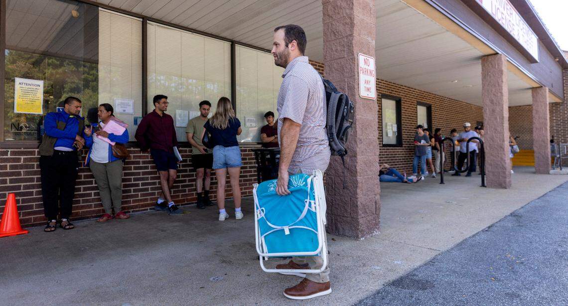 Drew Duckett brings a lawn chair to sit in while waiting in line outside the NCDMV driver license office on Avent Ferry Road in Raleigh on Thursday, August. 29, 2024. It was Duckett’s third attempt at obtaining a new license. As the state’s population grew by 2.4 million since 2003, the number of approved driver’s license examiners hasn’t changed, the Division of Motor Vehicles says.