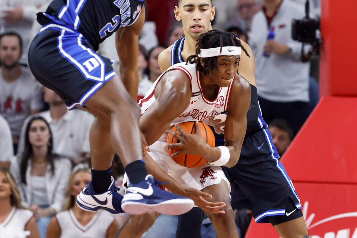 Arkansas’ Chandler Lawson (8) keeps the rebound from Duke’s Jaylen Blakes (2) and Christian Reeves (21) during the first half of Duke’s game against Arkansas at Bud Walton Arena in Fayetteville, Ark., Weds. Nov. 29, 2023.