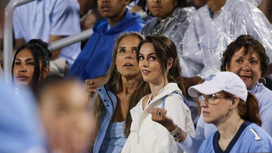 Jordon Hudson, center, girlfriend of UNC Head Coach Bill Belichick, watches the video board from the stands during a timeout at the game between UNC-Charlotte and UNC-Chapel Hill at Jerry Richardson Stadium in Charlotte on Saturday, September 6, 2025.