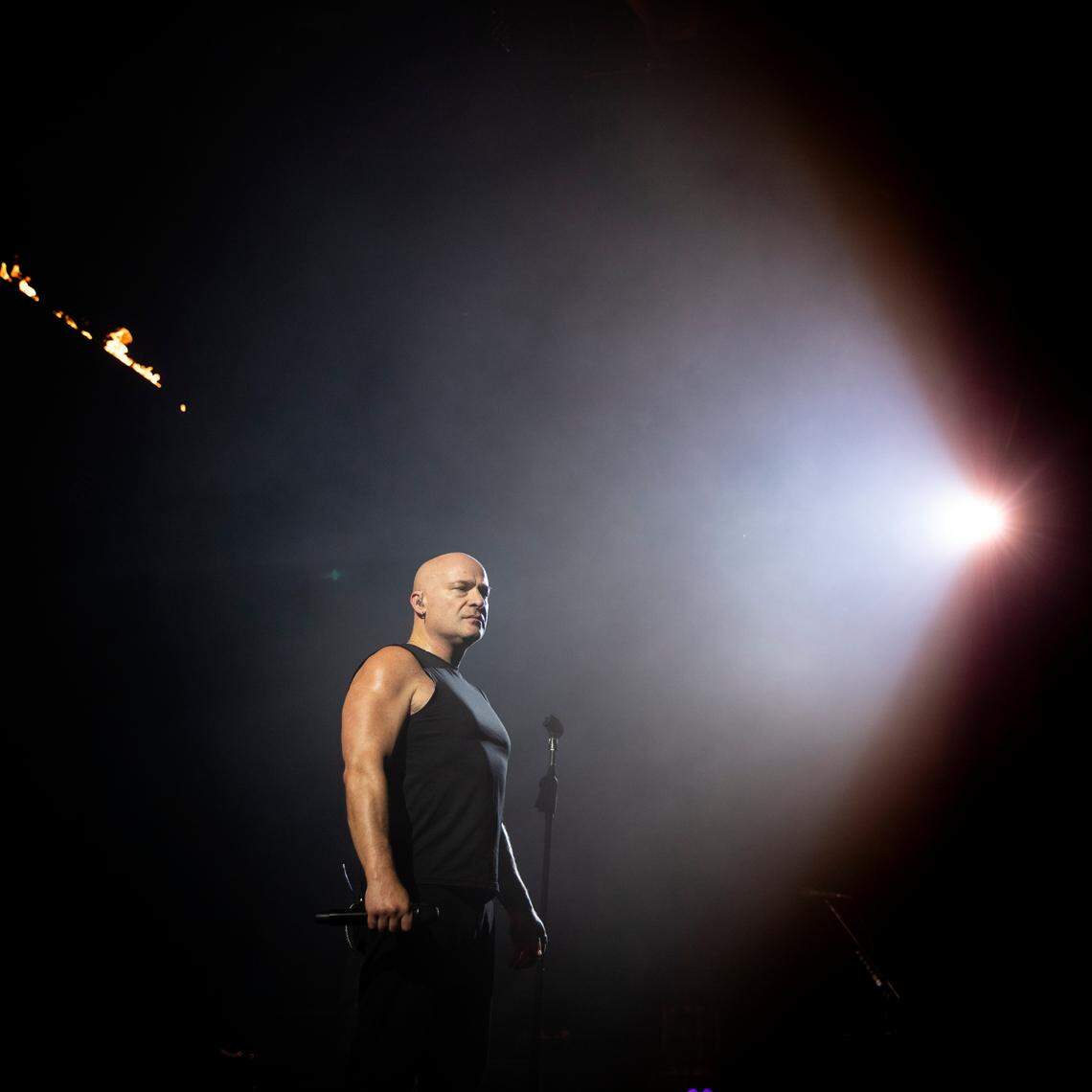 The spotlight illuminates Disturbed lead singer on their “Take Back Your Life Tour” to Raleigh, N.C.’s Coastal Credit Union Music Park at Walnut Creek, Wednesday night, Sept. 6, 2023.