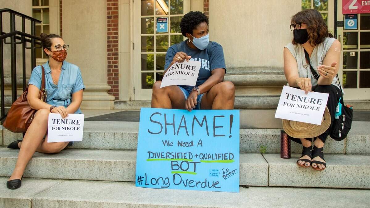 From left, Sarah Miles, a current graduate student, Carol Shirley, an alumni, and Deborah Dwyer, a doctoral candidate, gather on the steps of Carroll Hall, where the UNC-Chapel Hill Hussman School of Journalism and Media is located, before the university’s Board of Trustees is scheduled to vote on tenure for distinguished journalist Nikole Hannah-Jones, on Wednesday, Jun. 30, 2021, in Chapel Hill, N.C.