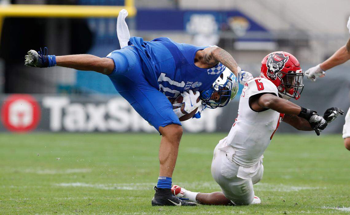 N.C. State safety Jakeen Harris (6) tackles Kentucky running back Asim Rose Jr. (10). during the first half of N.C. State’s game against Kentucky in the Gator Bowl at TIAA Bank Field in Jacksonville, Fla., Saturday, January 2, 2021.