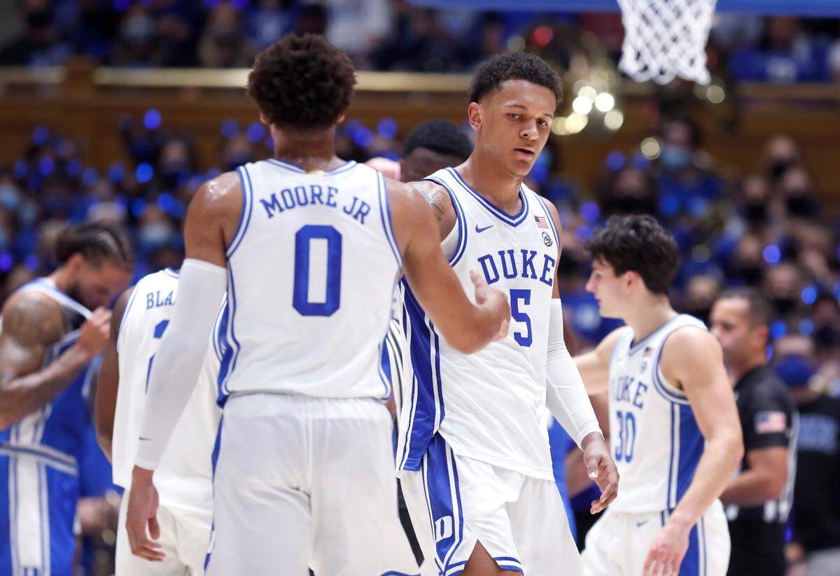 Duke’s Wendell Moore Jr. (0) and Paolo Banchero (5) slap hands after Banchero was fouled making a shot during Countdown to Craziness at Cameron Indoor Stadium in Durham, N.C., Friday, October 15, 2021.