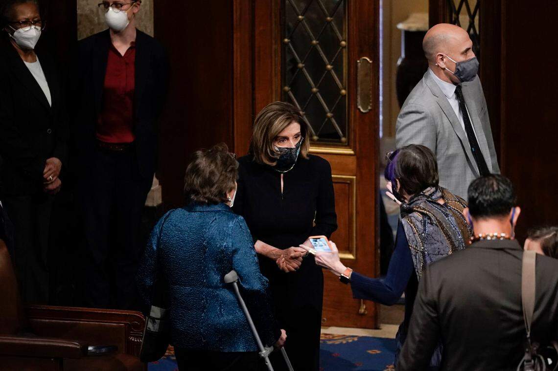 Speaker of the House Nancy Pelosi, D-Calif., speaks with Rep. Rosa DeLauro, D-Conn., after the U.S. House voted to impeach President Donald Trump in Washington, Wednesday, Jan. 13, 2021. Trump is charged with “incitement of insurrection” over the deadly mob siege of the Capitol in a swift and stunning collapse of his final days in office.