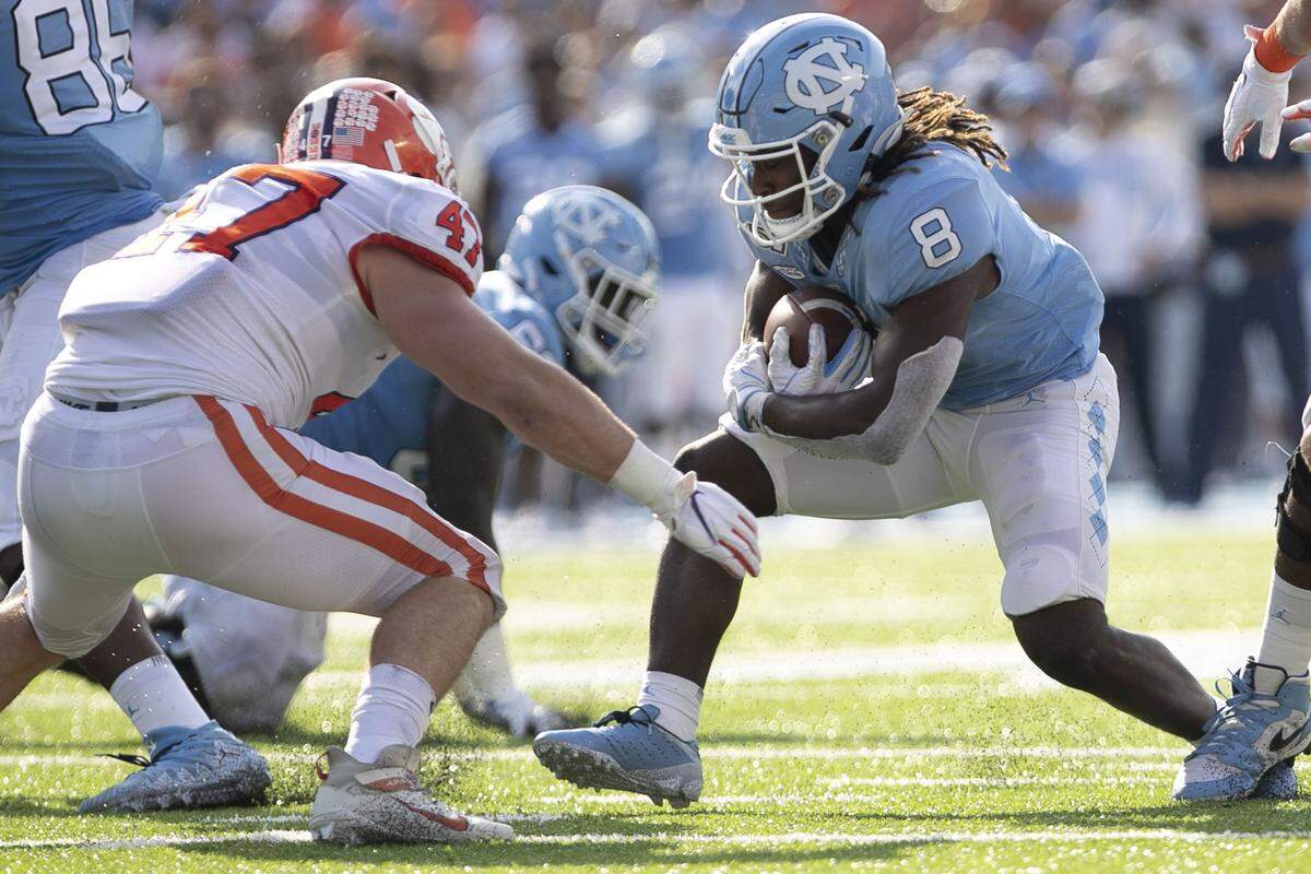 North Carolina’s Michael Carter (8) rushes for two yards to set up the Tar Heels’ touchdown in the second quarter against Clemson on Saturday, September 28, 2019 at Kenan Stadium in Chapel Hill, N.C.