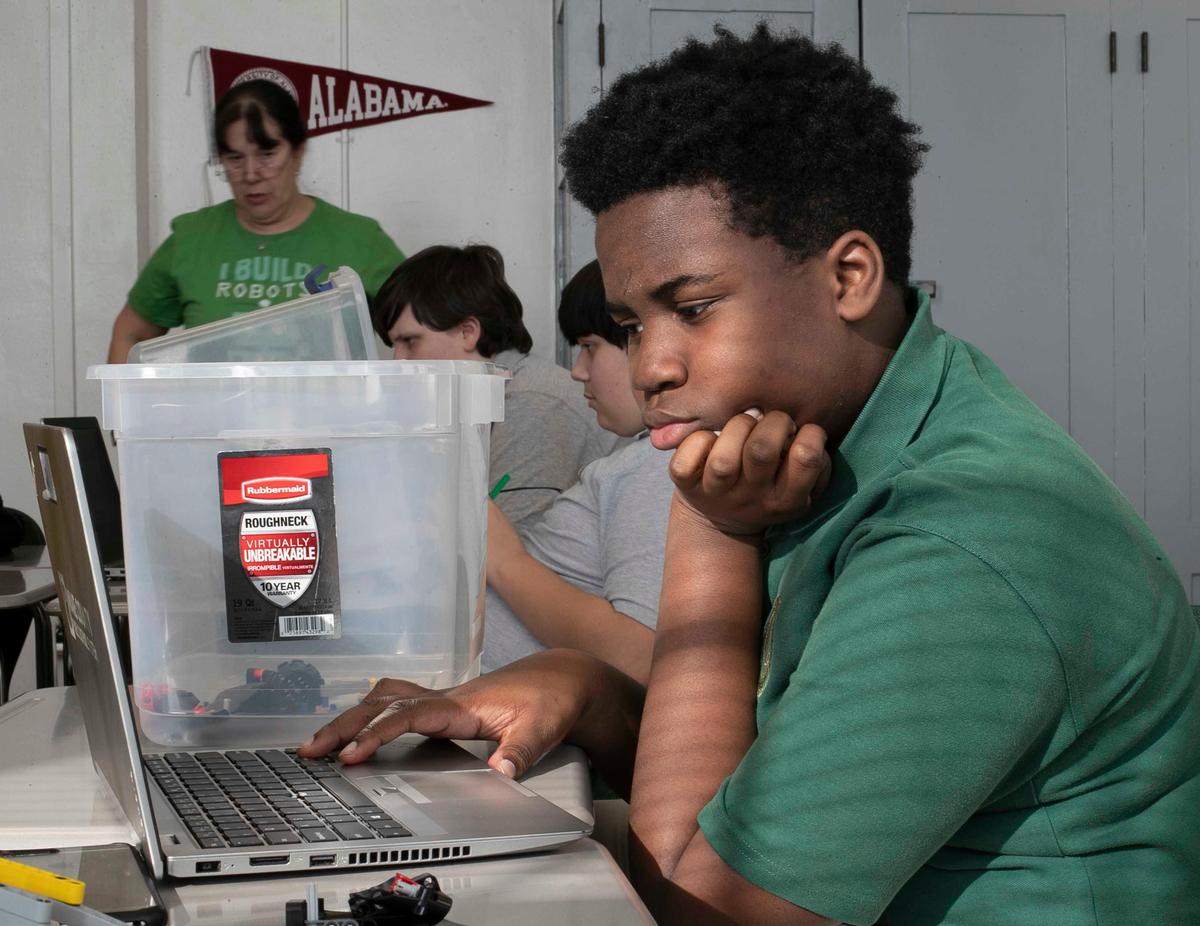 Eighth-grader Joseph Inkumsah uses a laptop during an after-school robotics club meeting on Thursday, January 30, 2020 at Wake Young Men’s Leadership Academy in Raleigh, N.C.