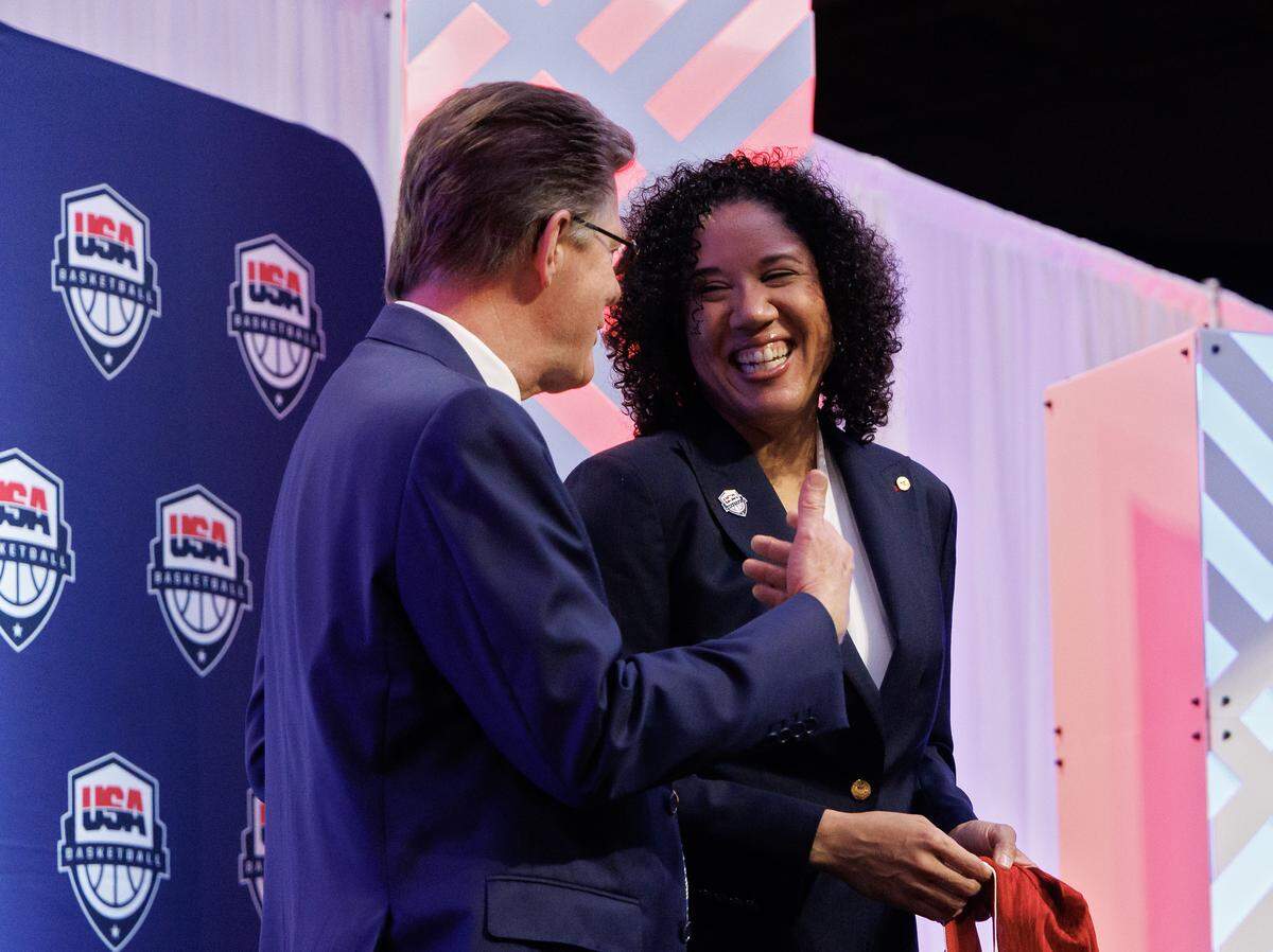 Duke women’s basketball head coach Kara Lawson smiles while talking with Duke University President Vincent Price after being named the 2025-2028 USA Basketball Women’s National Team head coach during a ceremony at Cameron Indoor Stadium on Tuesday, Sept. 23, 2025, in Durham, N.C.