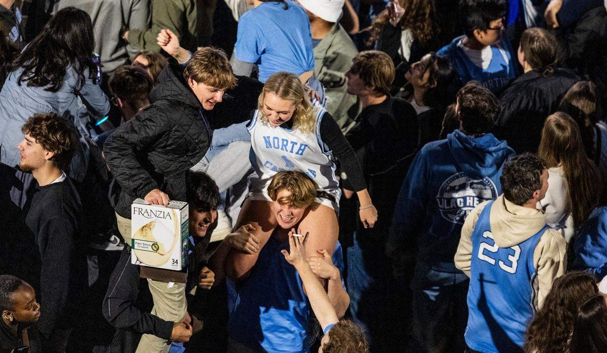 UNC-Chapel Hill basketball fans celebrate on Franklin Street following the UNC men’s basketball team’s 84-79 win over Duke at Cameron Indoor Stadium on Saturday, March, 9, 2024.
