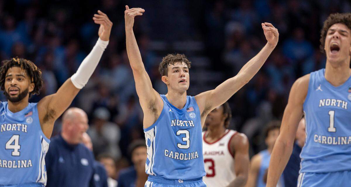 North Carolina’s R.J. Davis (4), Cormac Ryan (3) and Zayden High (1) work the crowd as the Tar Heels open a 57-43 lead over Oklahoma in the second half on Wednesday, December 20, 2023 at the Spectrum Center in Charlotte, N.C. The Tar Heels defeated the Sooners 81-69.