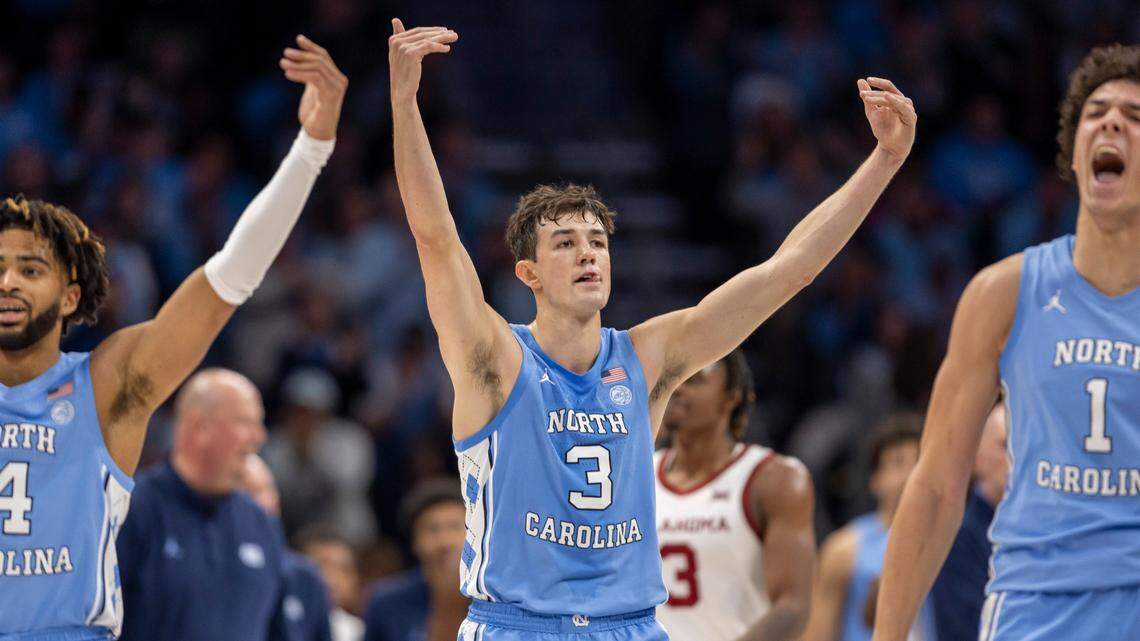 North Carolina’s R.J. Davis (4), Cormac Ryan (3) and Zayden High (1) work the crowd as the Tar Heels open a 57-43 lead over Oklahoma in the second half on Wednesday, December 20, 2023 at the Spectrum Center in Charlotte, N.C. The Tar Heels defeated the Sooners 81-69.