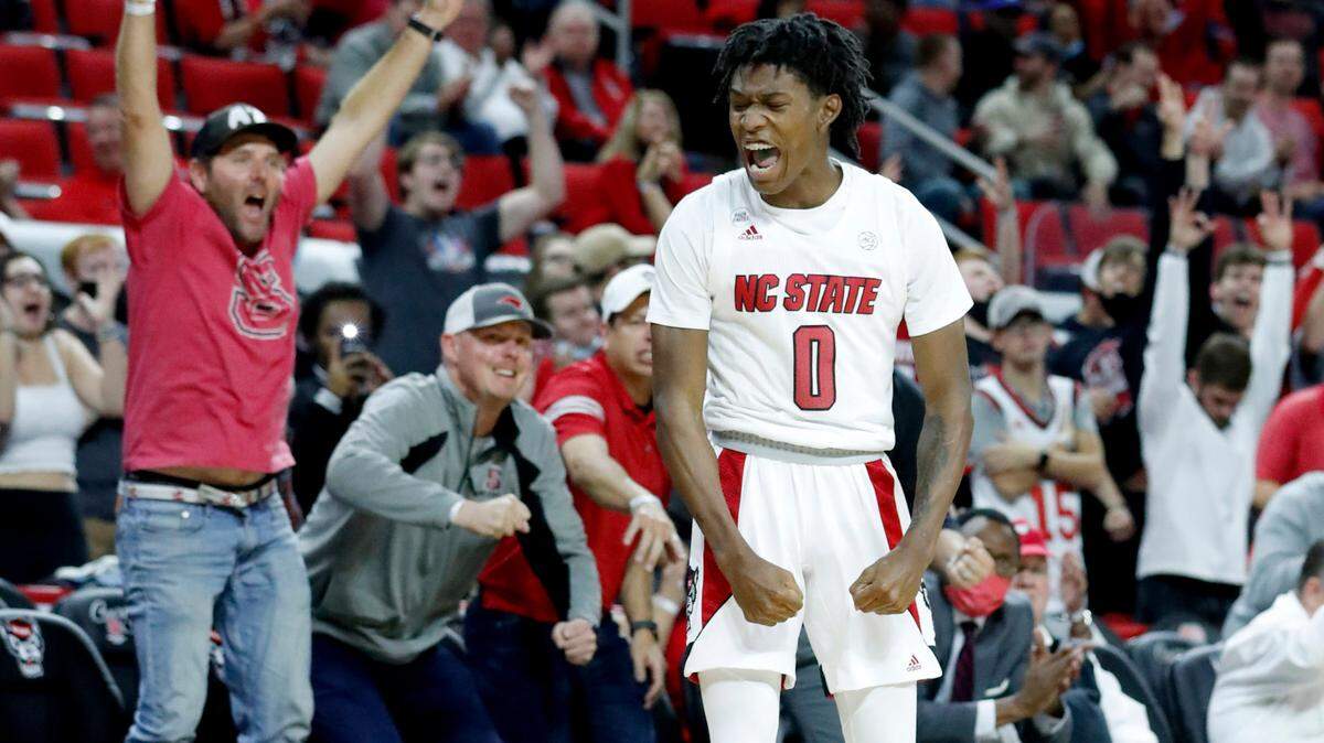 N.C. State’s Terquavion Smith (0) celebrates hitting a three-pointer in the fourth overtime during N.C. State’s 104-100 victory over Nebraska in four overtimes at PNC Arena in Raleigh, N.C., Wednesday, December 1, 2021.