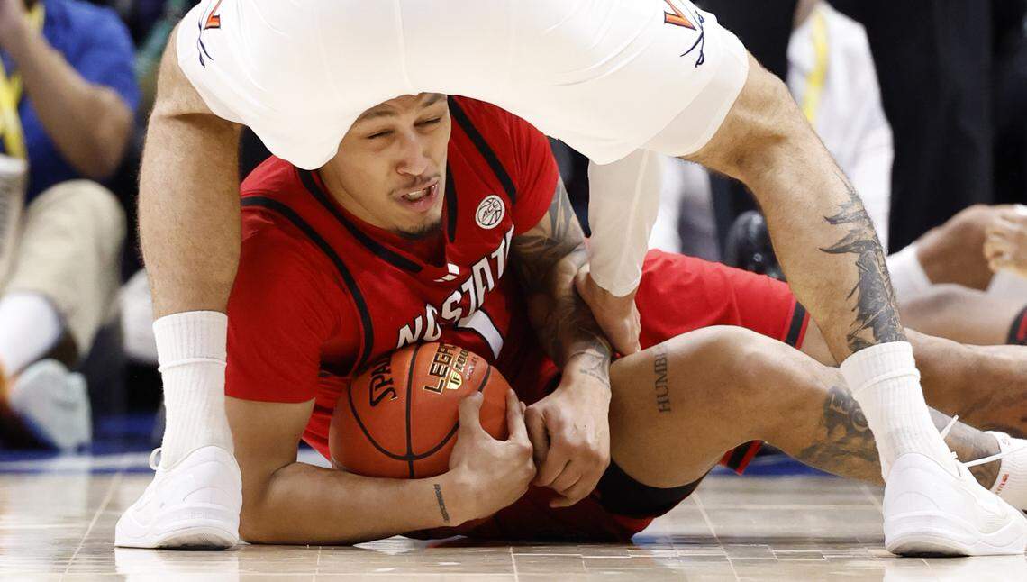 N.C. State's Darrion Williams (1) dives on a loose ball in the second half of Virginia’s 81-74 victory over N.C. State in the quarterfinals of the 2026 ACC Men’s Basketball Tournament at the Spectrum Center in Charlotte, N.C., Thursday, March 12, 2026.