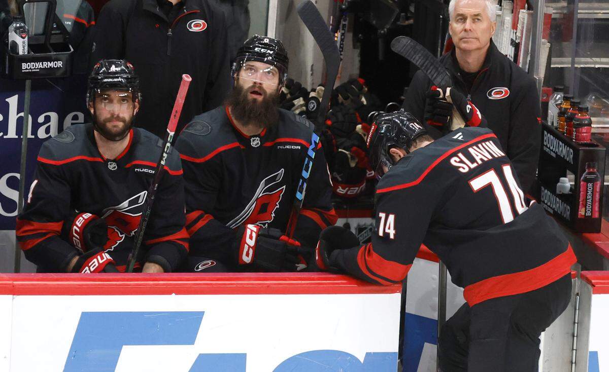 Carolina’s Shayne Gostisbehere (4), Brent Burns (8) and Jaccob Slavin (74) react after the Panthers scored during the third period of the Florida Panthers’ 5-0 victory over the Carolina Hurricanes in Game 2 of the Eastern Conference Final at the Lenovo Center in Raleigh, N.C., Thursday, May 22, 2025.