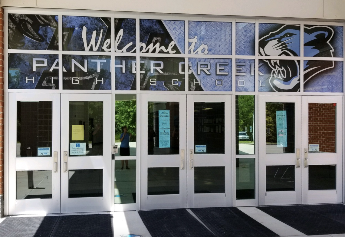 An employee at Panther Creek High School has been suspended after students saw them placing their knee on a student’s neck while trying to break up a fight, said the school’s principal, Greg Decker.